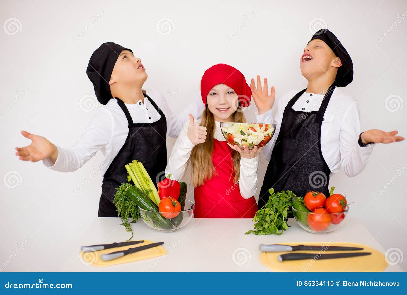 Three Young Chefs Evaluate a Salad Isolated Stock Photo Image of cook