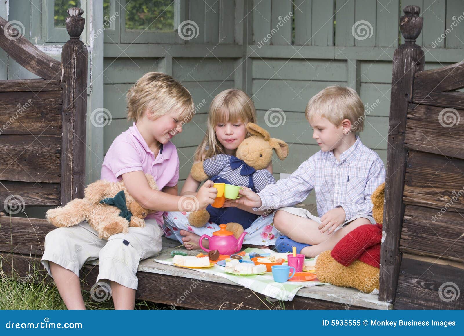Three Young Children In Shed Playing Tea Royalty Free ...