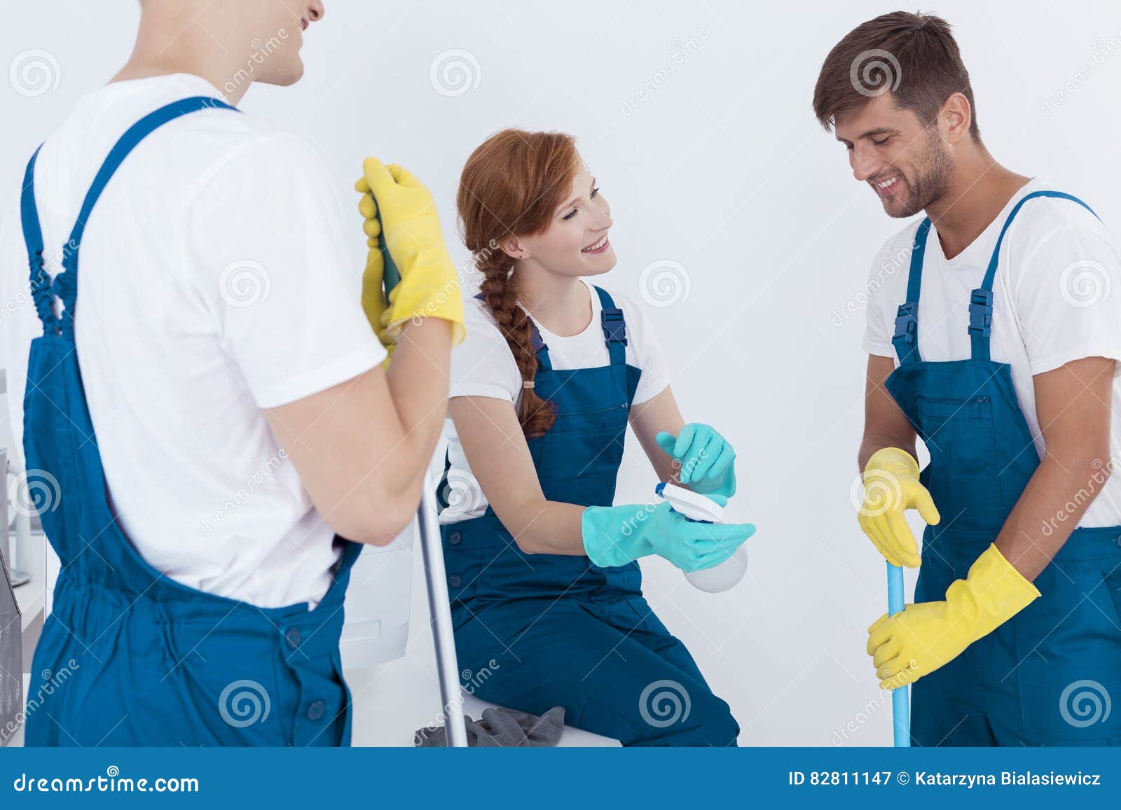 Three young cleaners stock image. Image of talking, happy 82811147