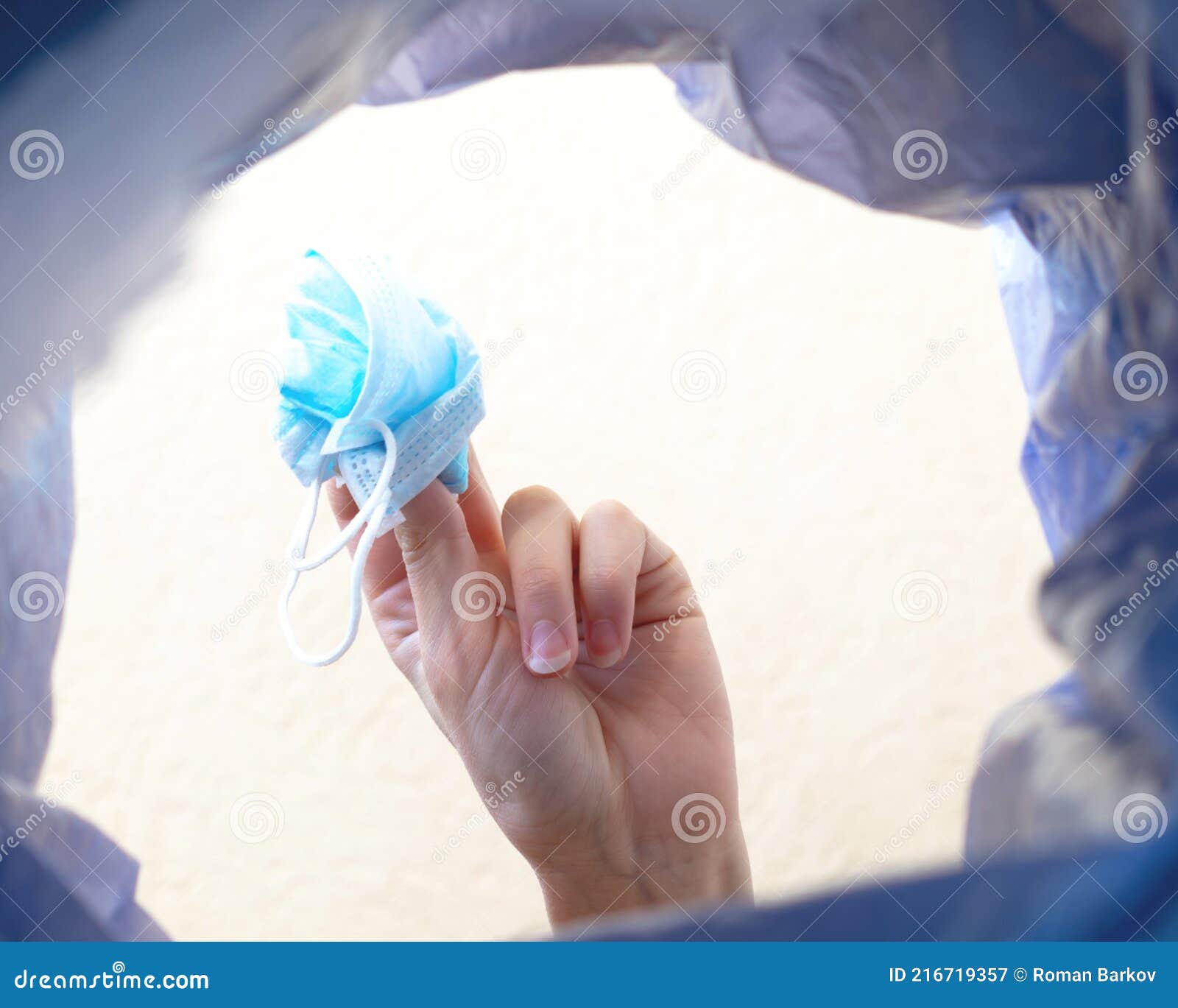 Man Throwing Face Masks Into Trash In Park. Man Throwing Used Surgical