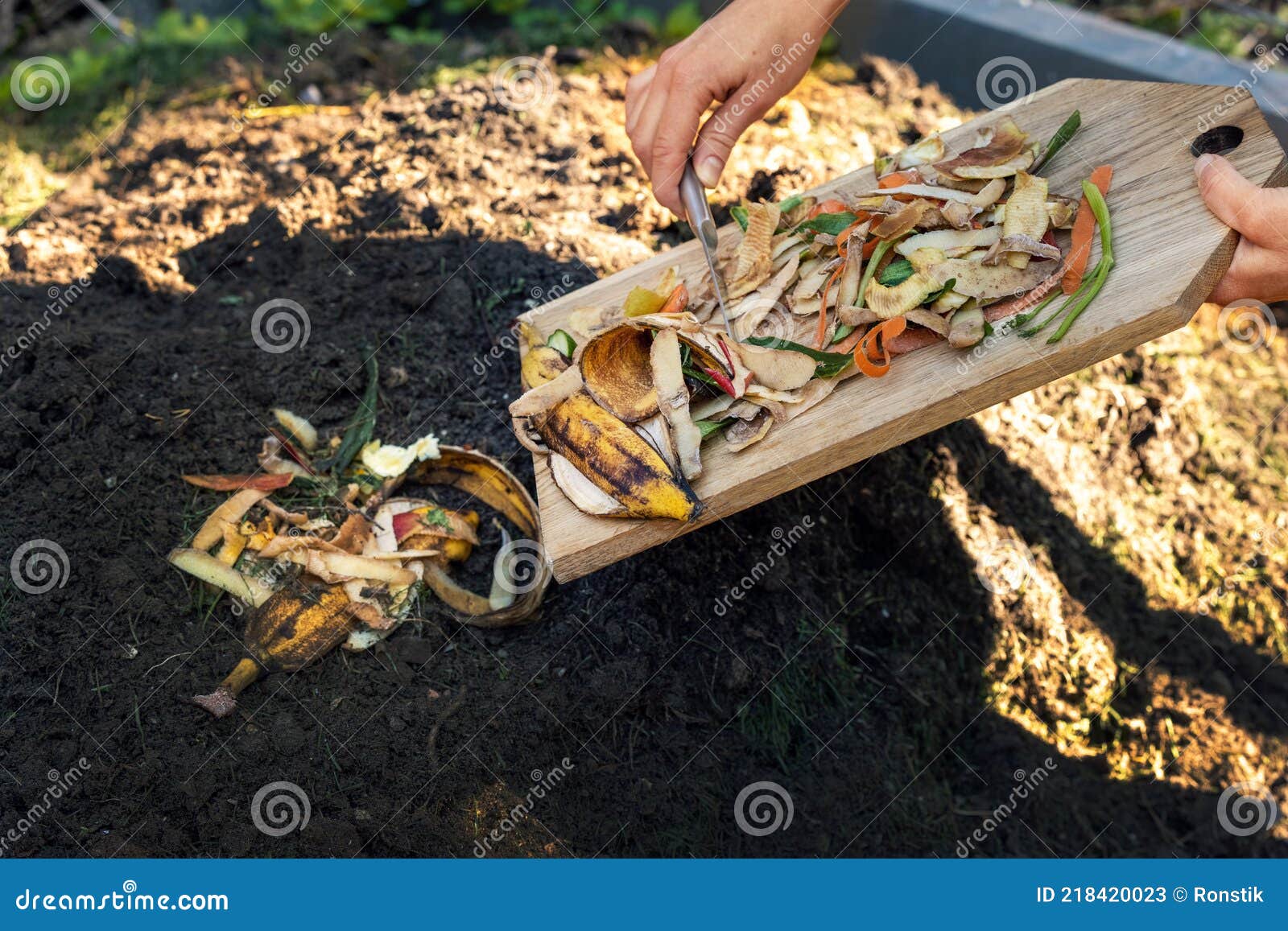 throwing food leftovers in garden compost pile. recycling organic kitchen waste