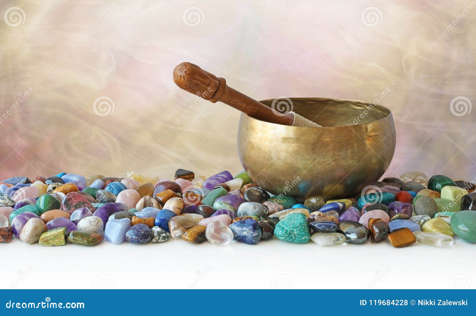 tibetan singing bowl surrounded by tumbled healing stones