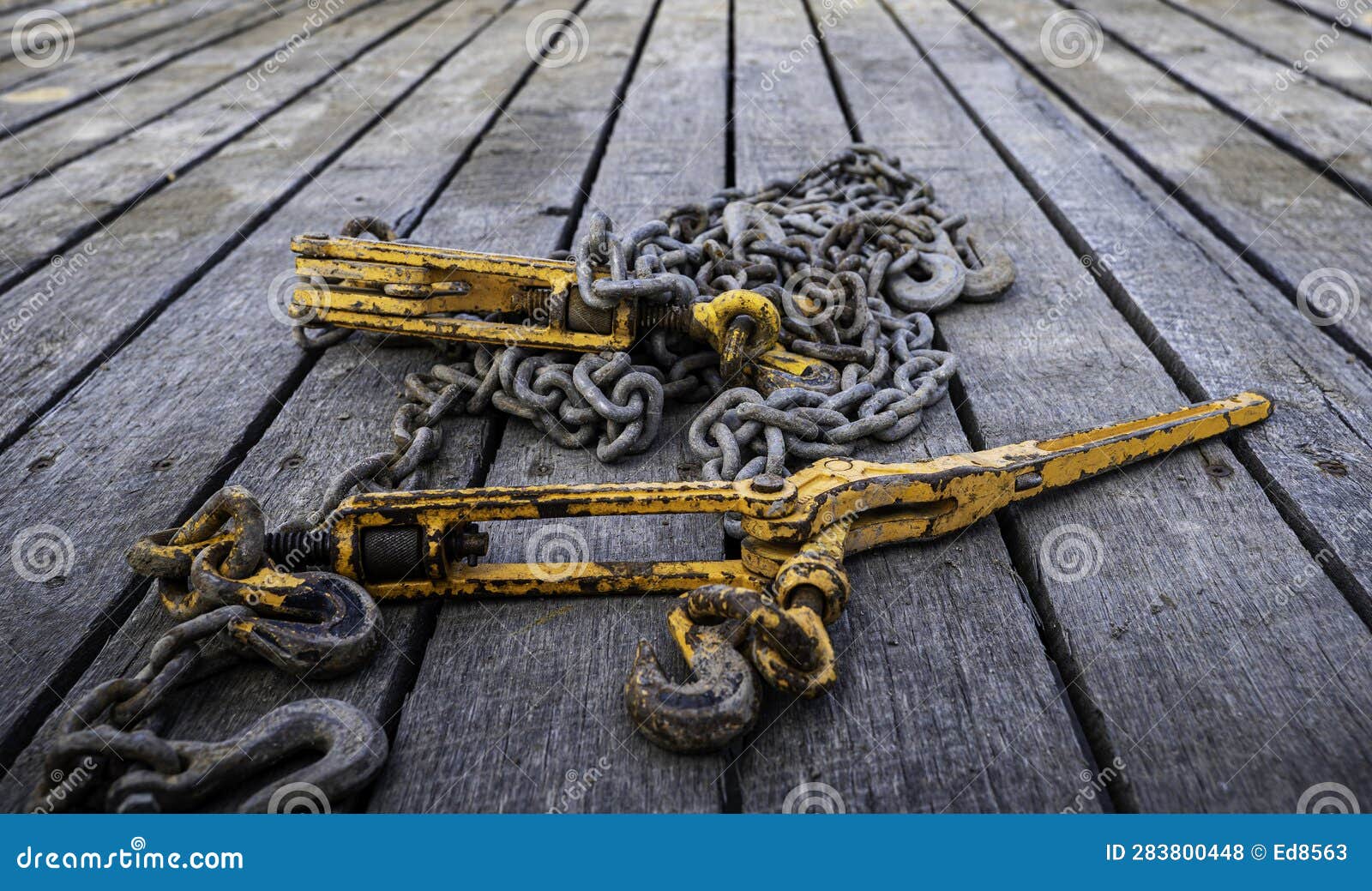 Tie Down Chains and Binders on Wood Boards of Flatbed Trailer Stock