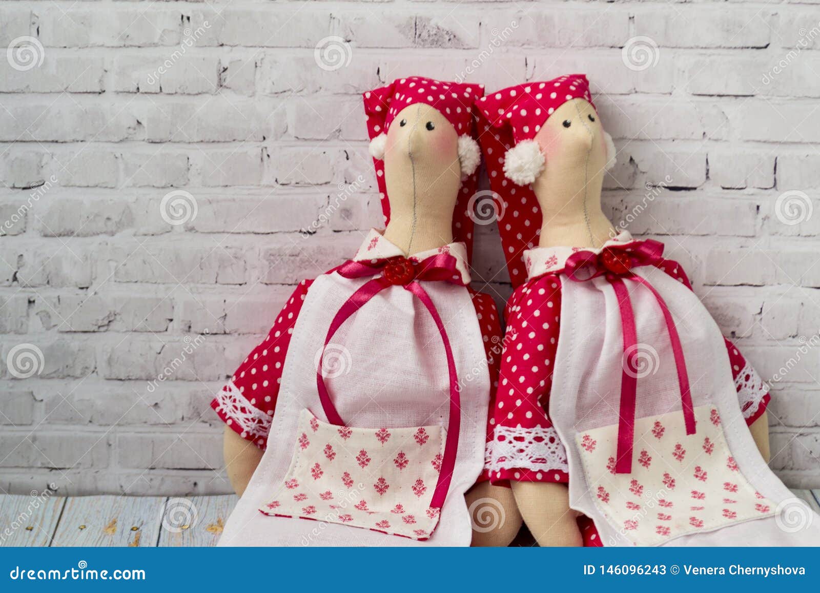 Tilda Doll, Soft Toy with a Heart, Sitting on a Wooden Background