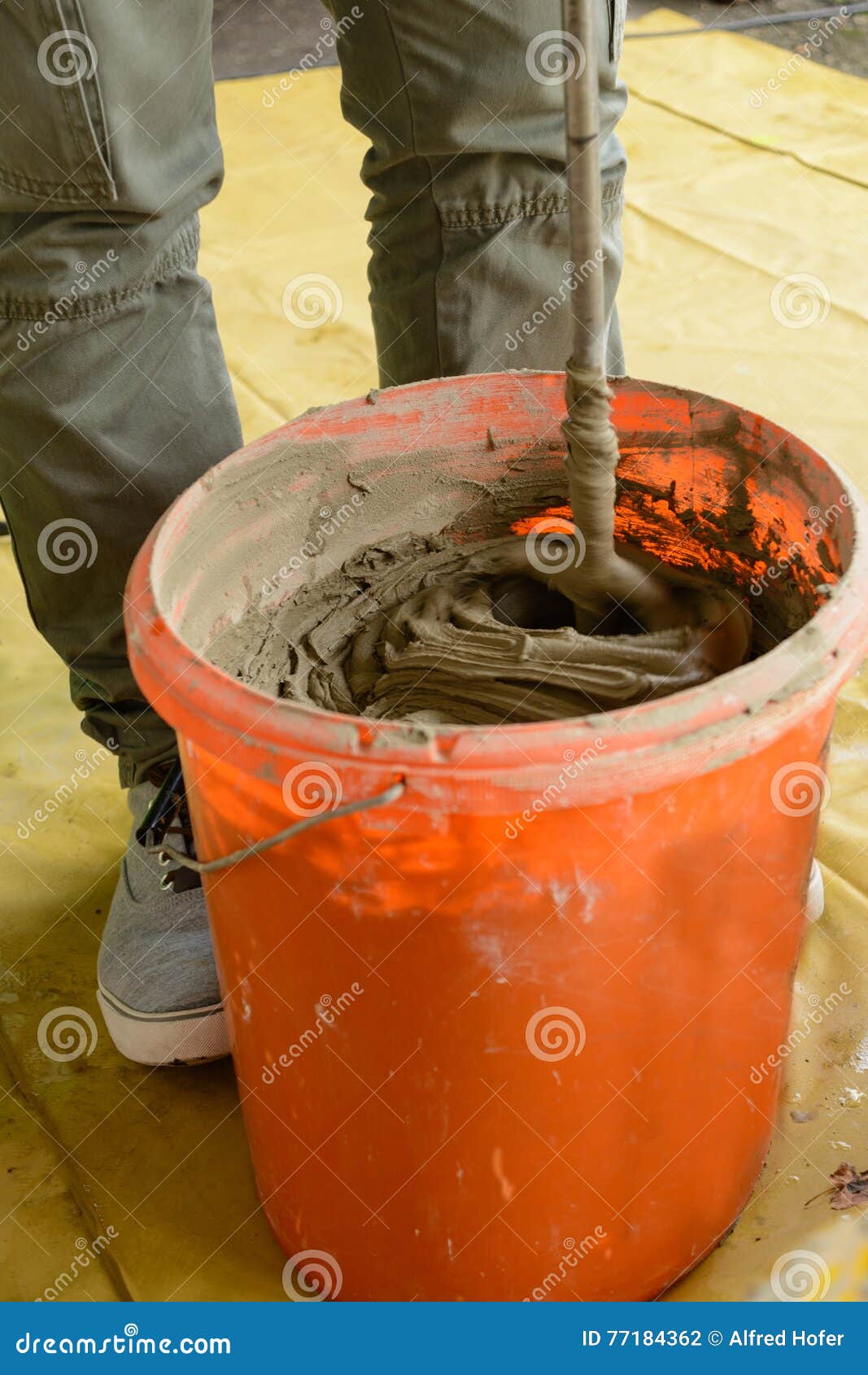 Mixed Tile Grout In A Plastic Bowl In A Construction Worker`s Hands