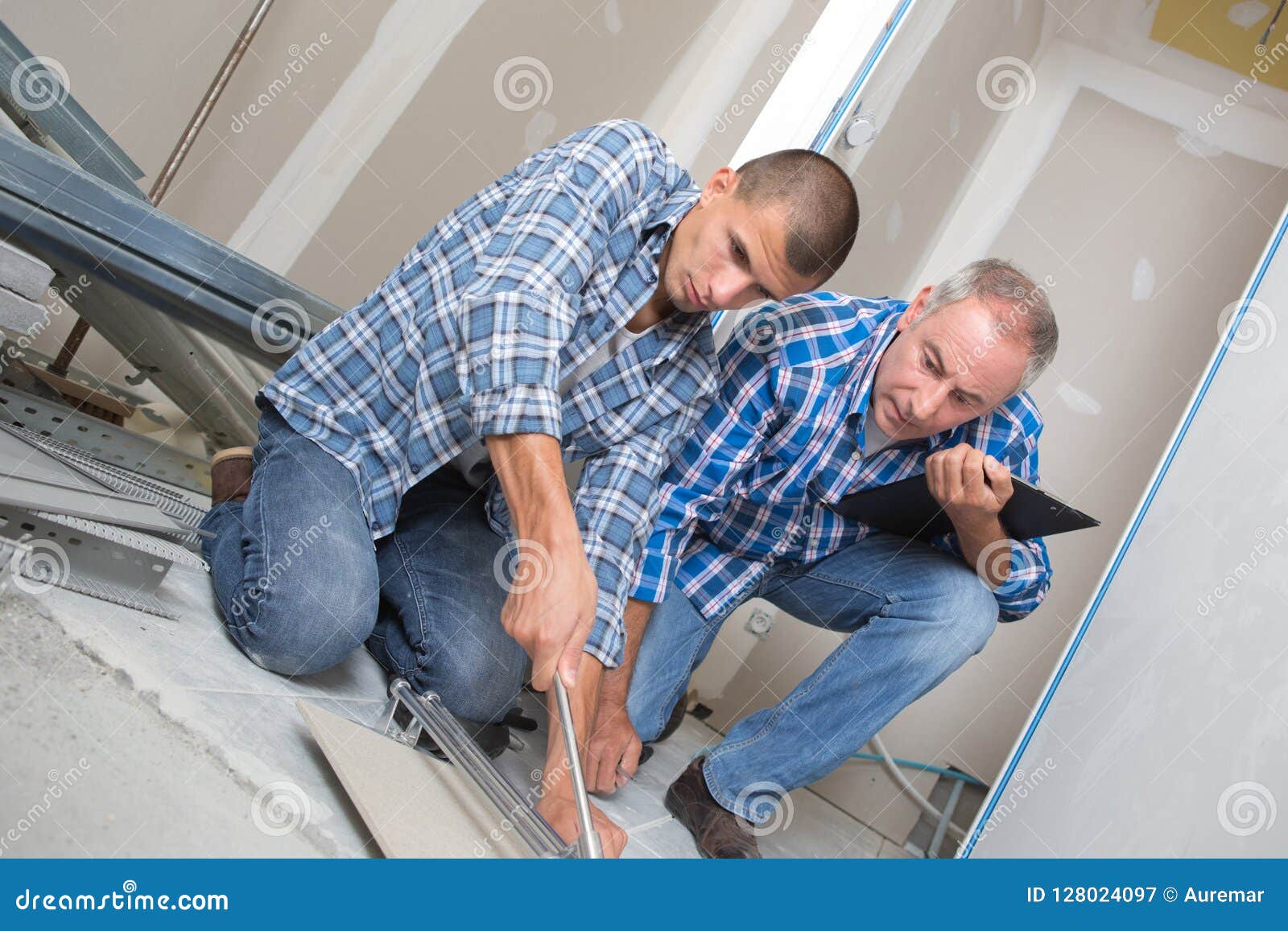 Tile Cutting Apprentice and Manager Working with Floor Tile Cutting
