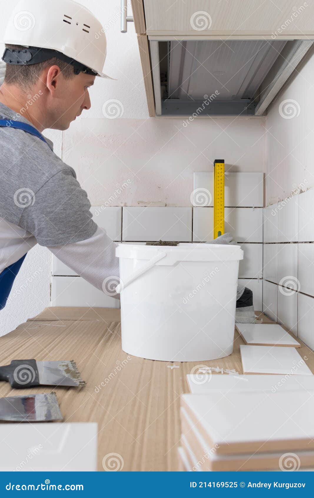 The Tile Installation Wizard Measures the Correct Laying of White Tiles