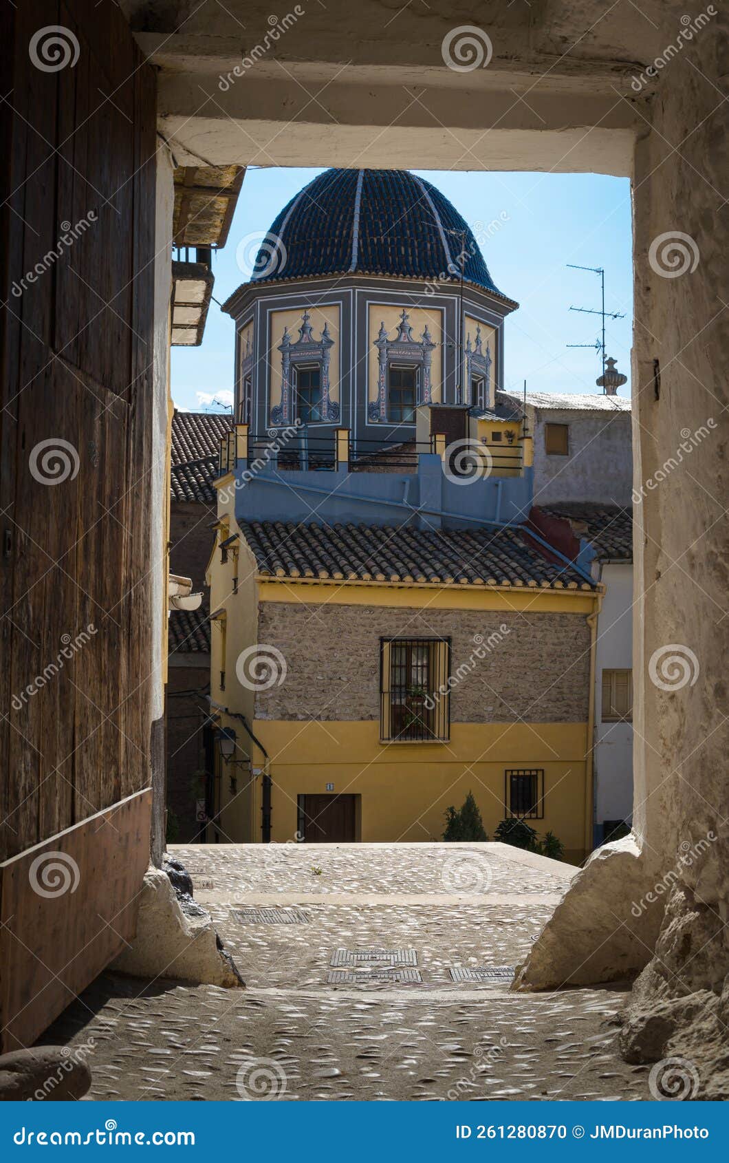 tiled dome of the parish church of our lady of the assumption through a porch, onda, castellon, spain