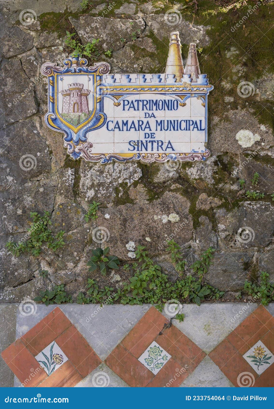 tiles painted with `patrimonio da camara municipal de sintra` seen along volta mounted on a brick wall in sintra.