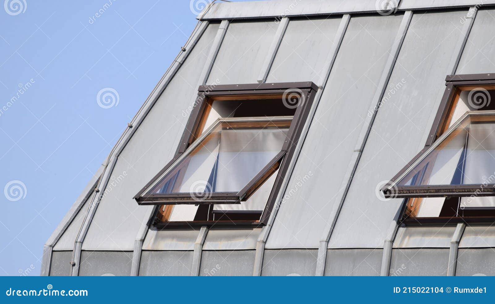 Tilted Pitched Roof Windows with Aluminum Sun Blinds Stock Photo