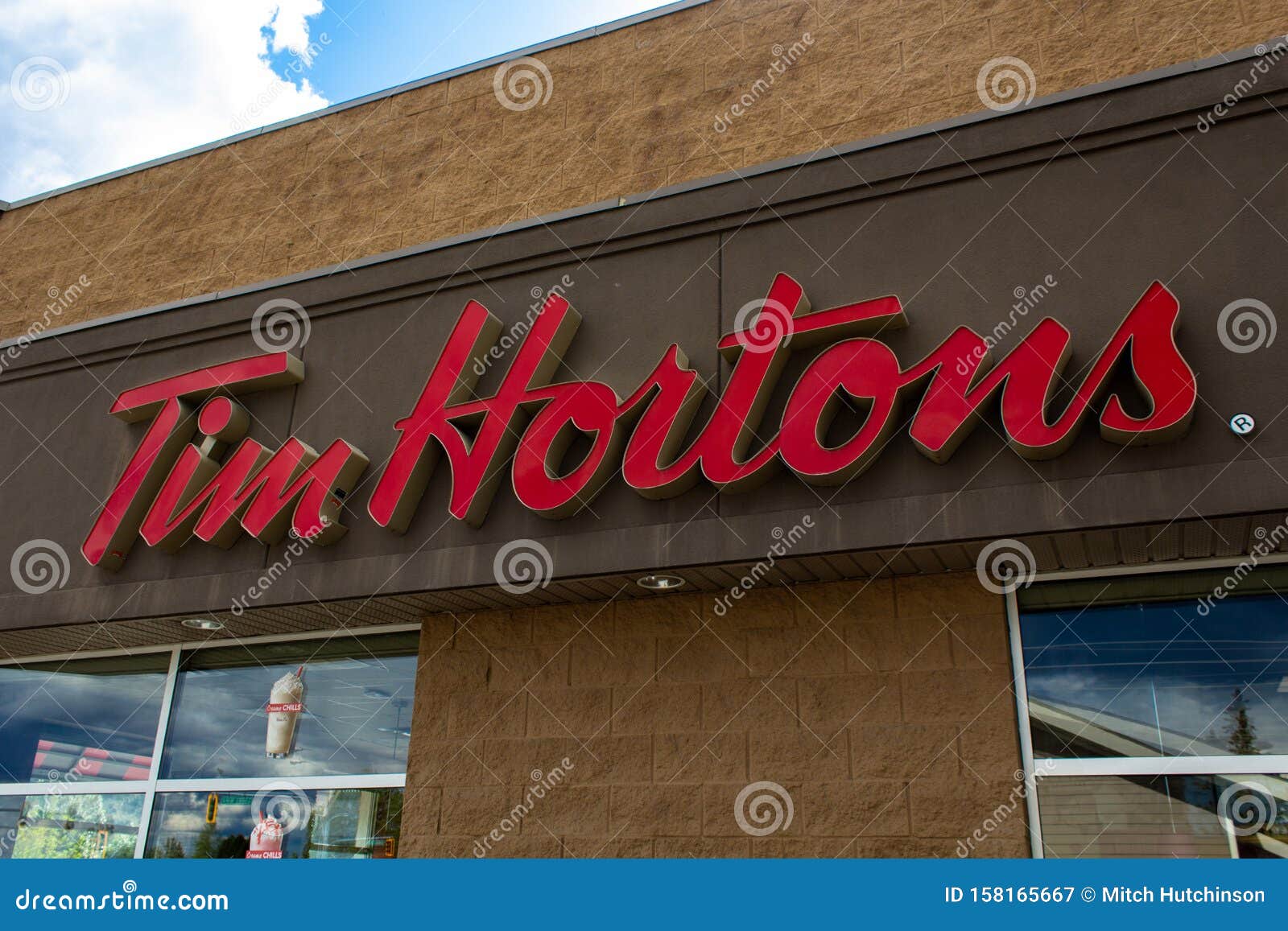 MONTREAL, CANADA - NOVEMBER 6, 2018: Tim Hortons Logo In Front Of One Of  Their Restaurants In Quebec With Their Slogan In French In The Background. Tim  Hortons Is A Cafe And