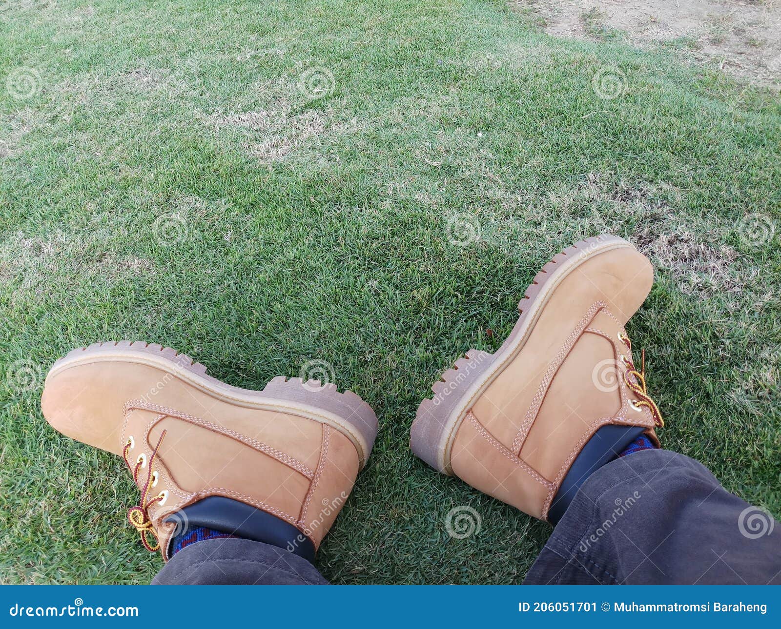 timberland brand men& x27;s shoes on green grass.