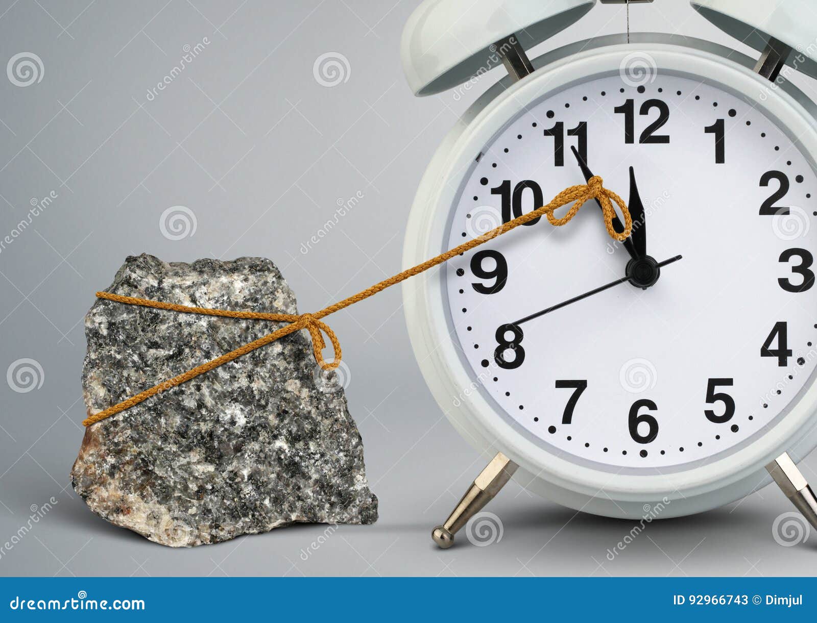time on alarm clock stop by stone, delay concept