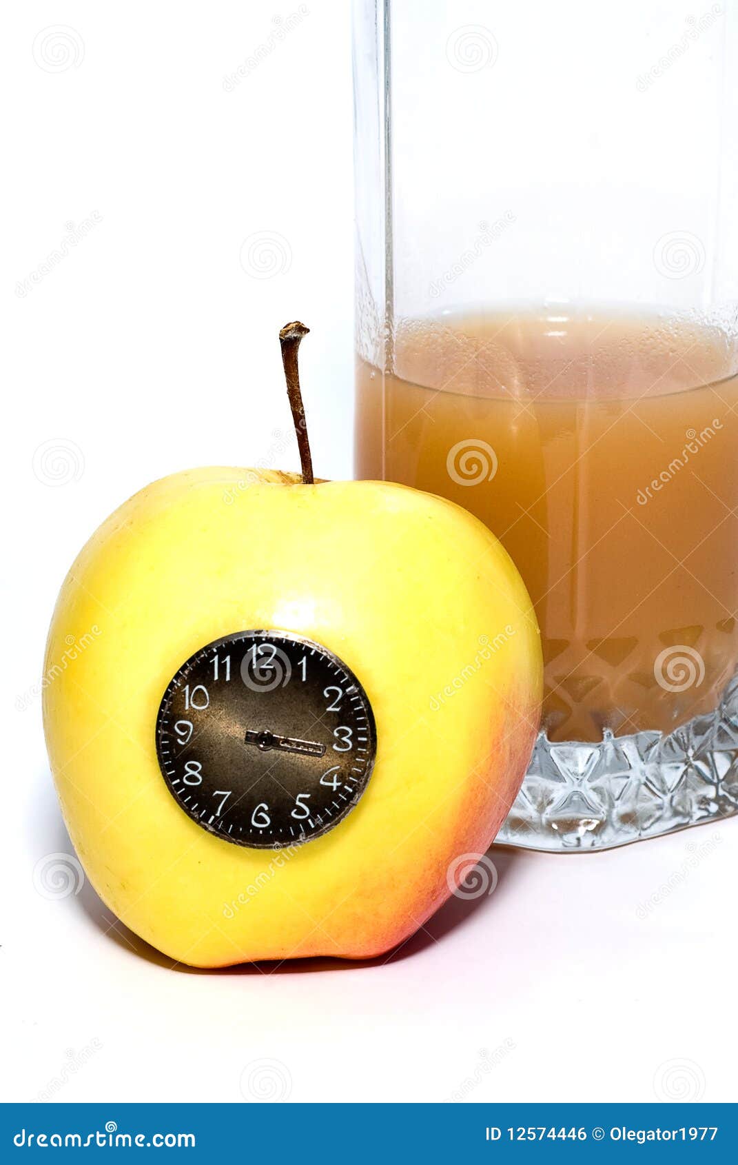Time of apple diet. Glass of juice behind the yellow apple with the clock