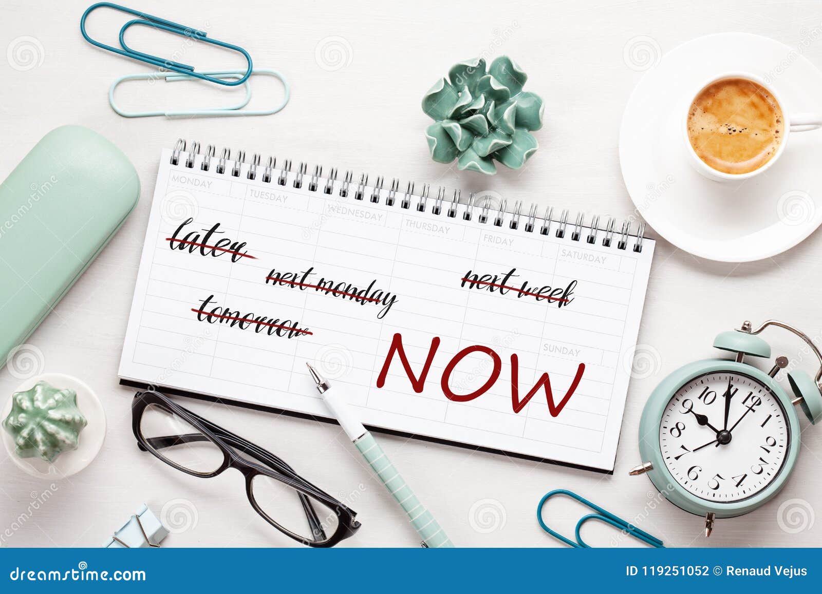 time management concept with notes in weekly organizer over the desk with coffee and alarm clock.