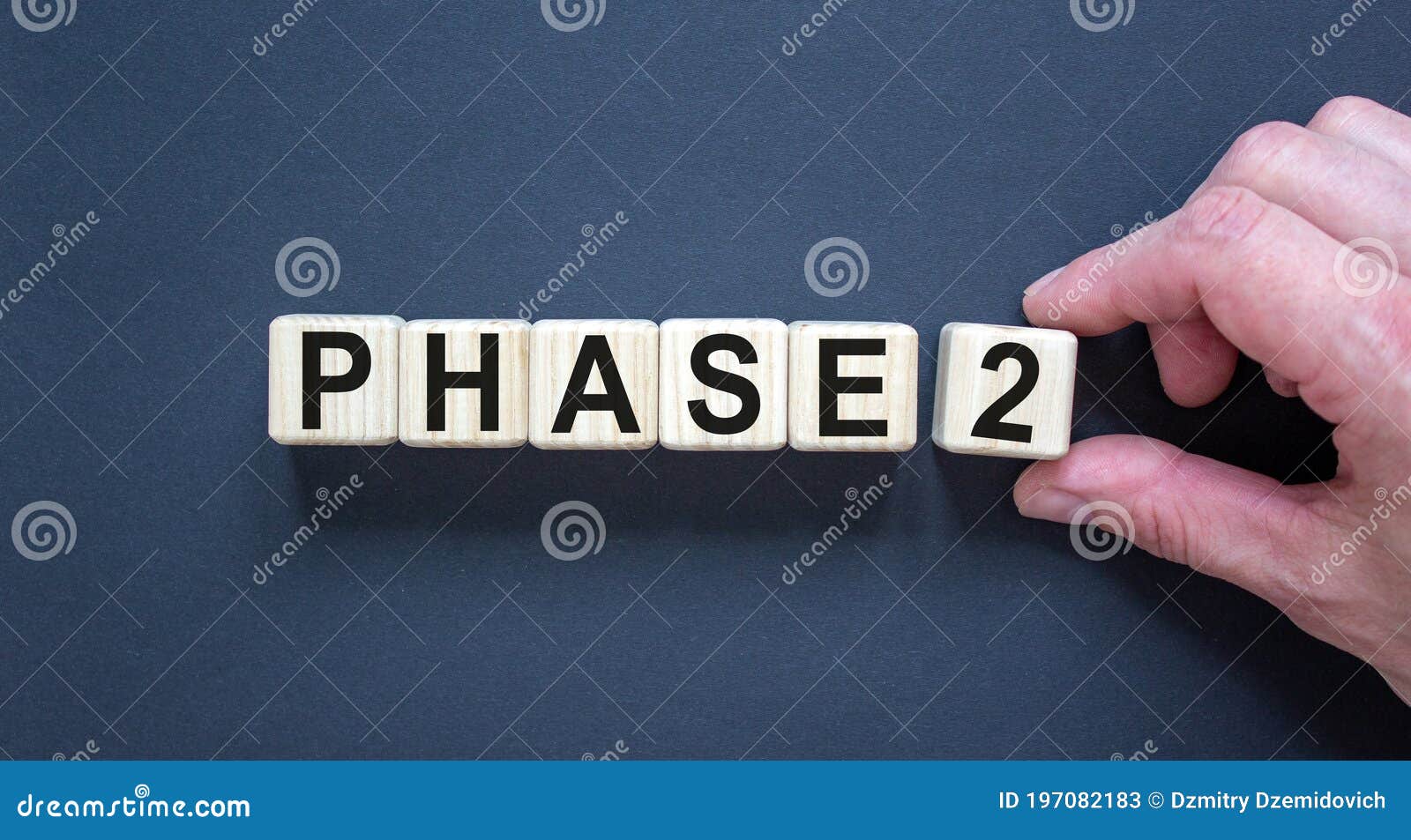time for phase 2. hand holds a cube with number `2`. word `phase 2`. beautiful black background. business concept. copy space