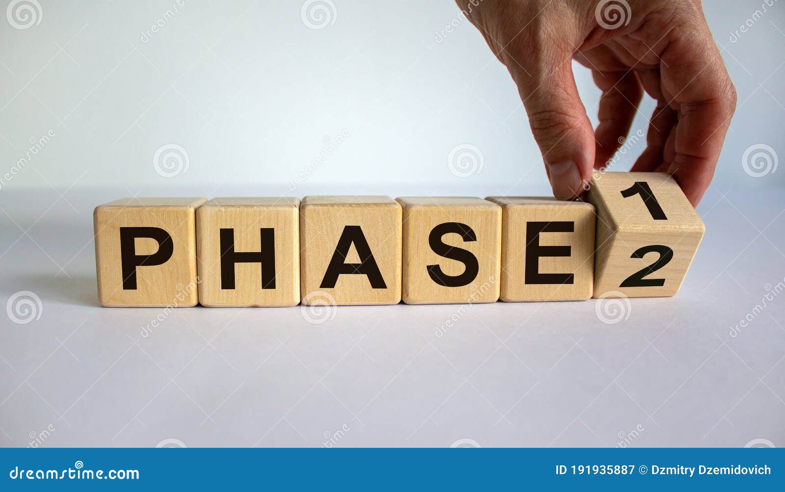 time for phase 2. hand is turning a cube and changes the word `phase 1` to `phase 2`. beautiful white background. business con