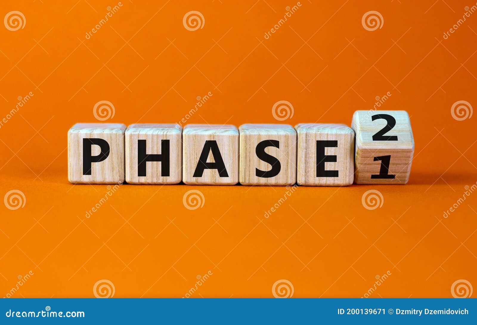 time for phase 2. turntd a cube and changed the word `phase 1` to `phase 2`. beautiful orange background. business concept. co