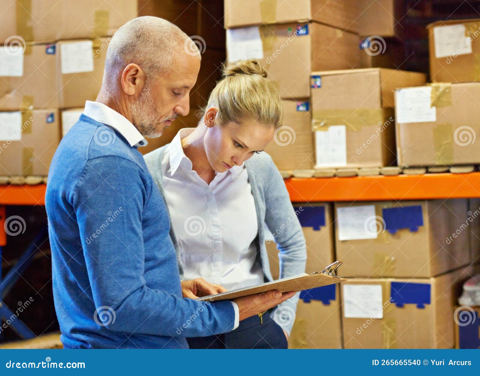 Time For A Stocktake. Two People Doing An Inventory Check In A