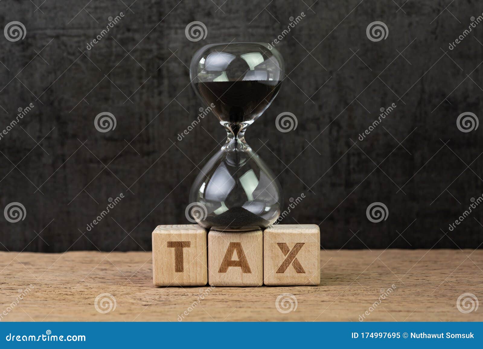 time for tax, countdown for tax day or taxation timer concept, sandglass or hourglass on wood block with alphabets combine word