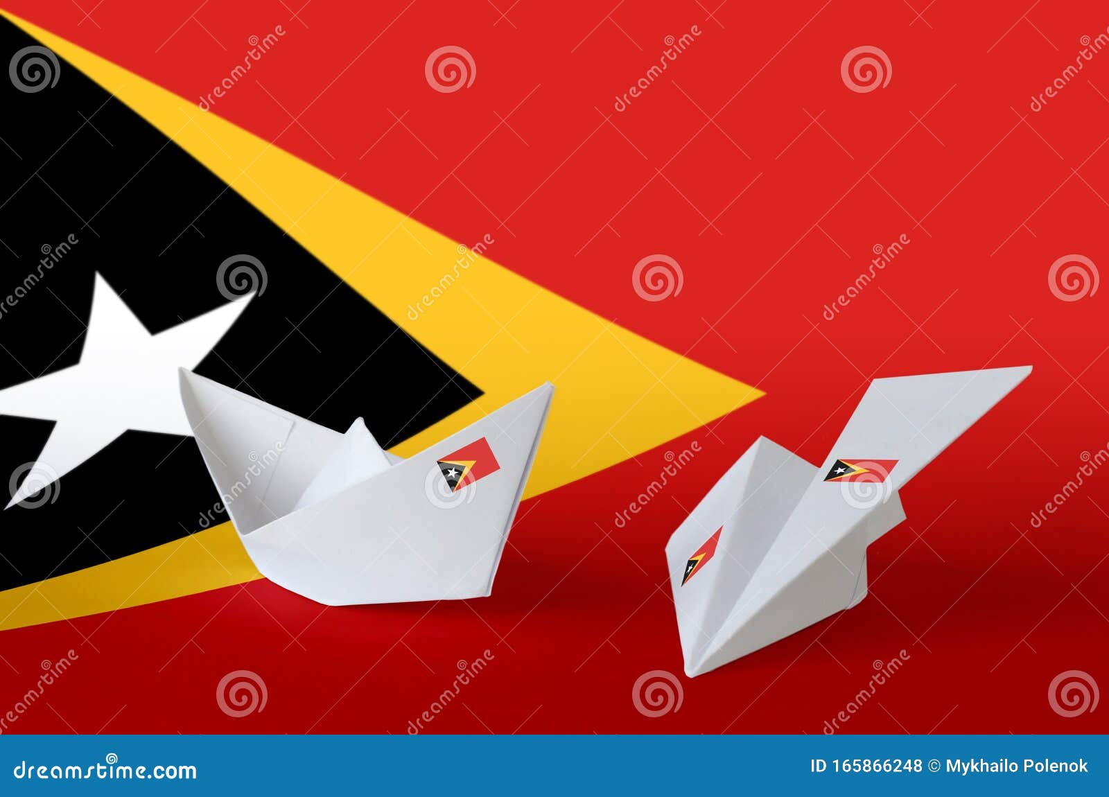 timor leste flag depicted on paper origami airplane and boat. handmade arts concept