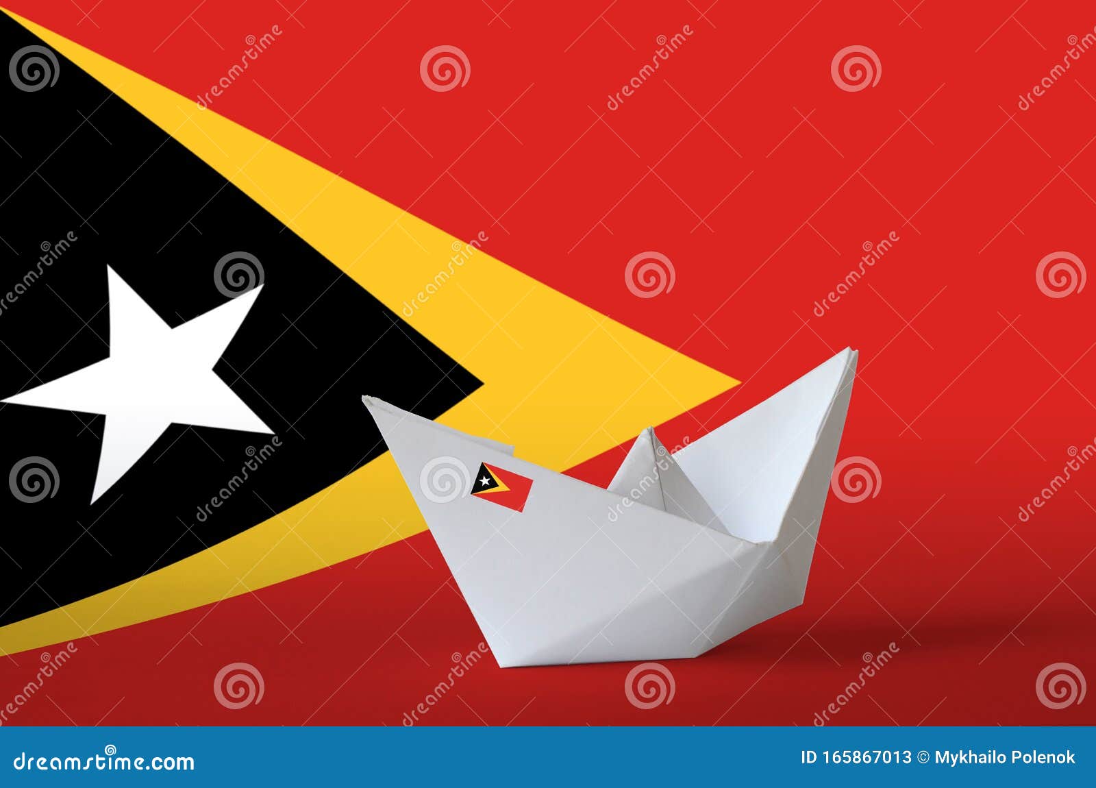 timor leste flag depicted on paper origami ship closeup. handmade arts concept
