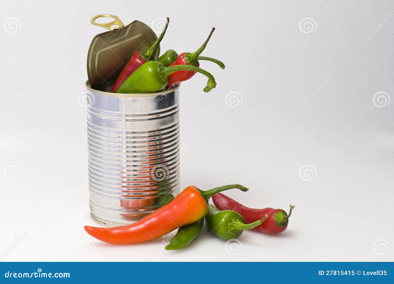 Tin of chillies. Stainless steel can with coloured chillies