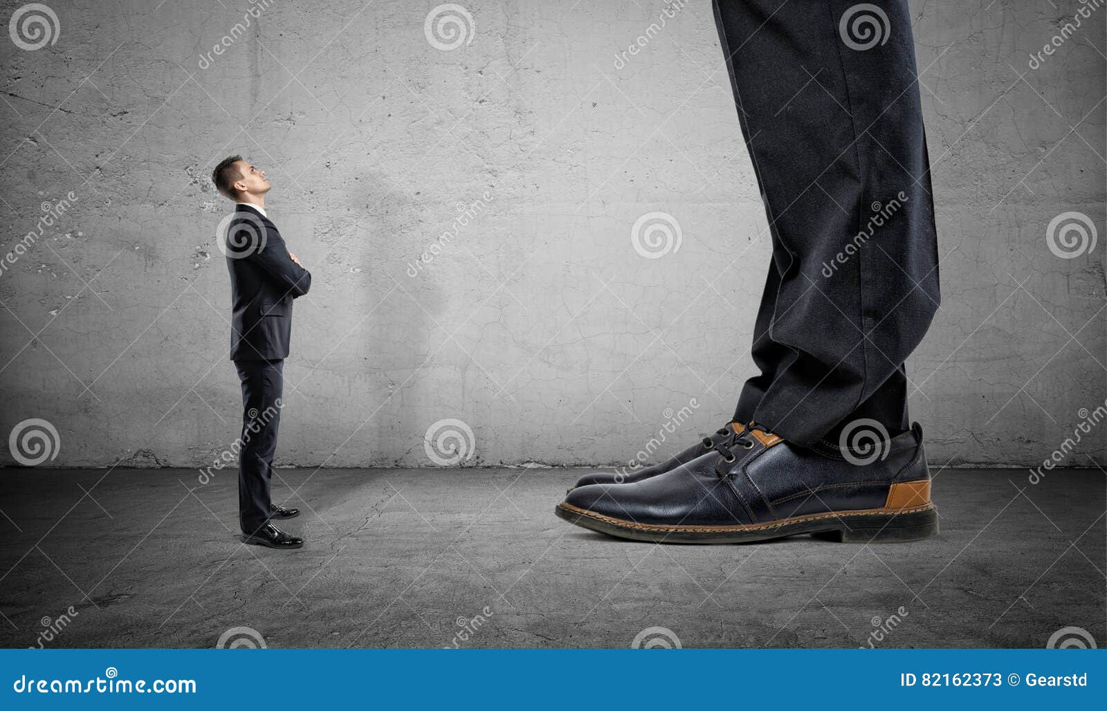 tiny businessman looking up on huge legs of another man