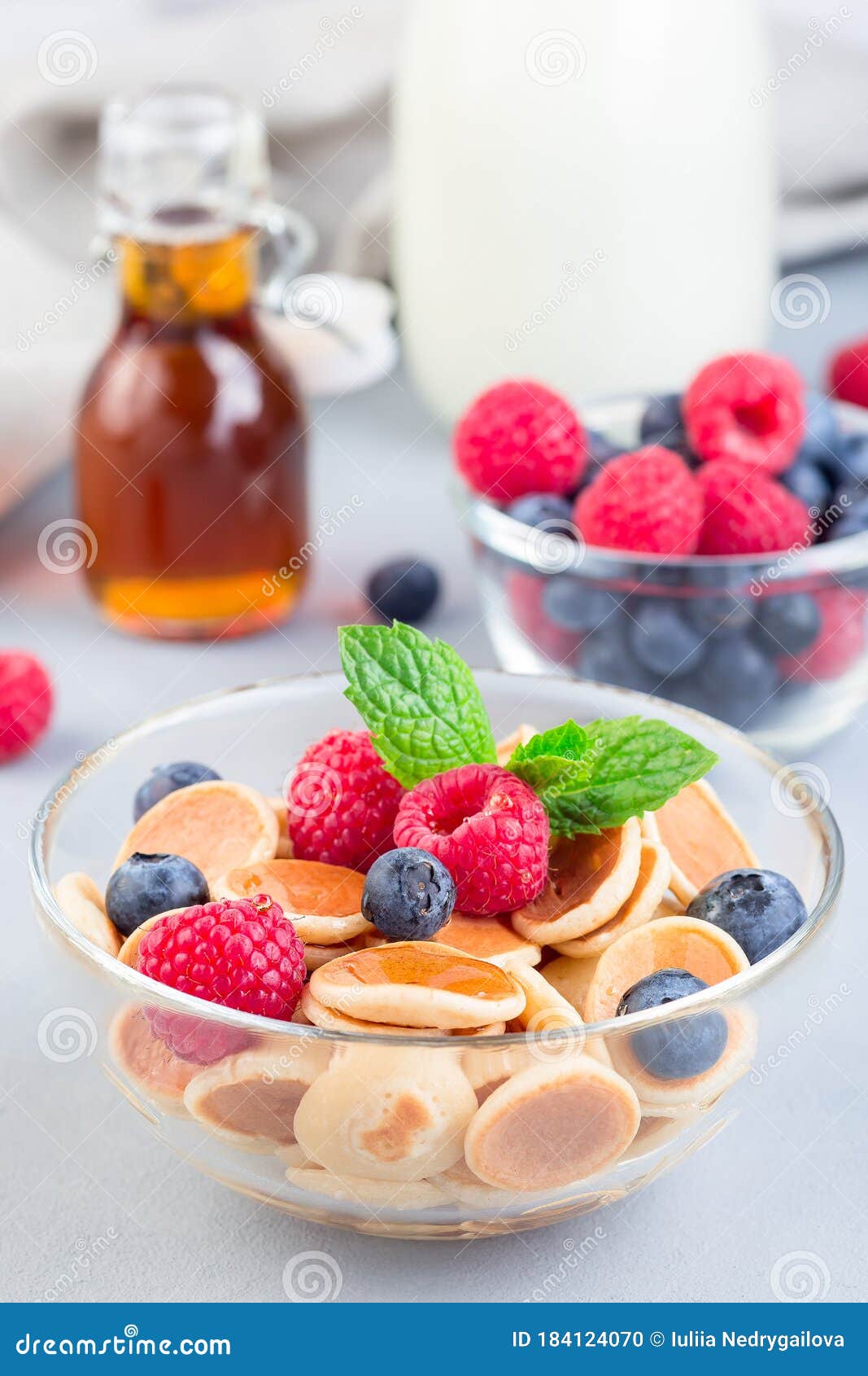Tiny Cereal Pancakes Served with Maple Syrup, Raspberry, Blueberry and