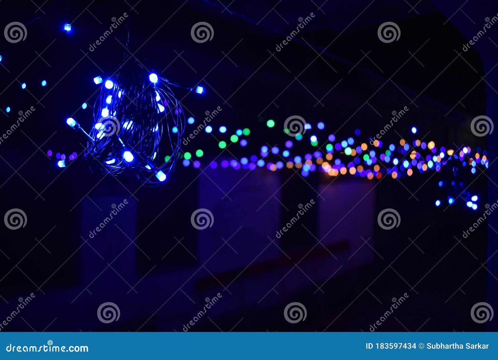 tiny colorful lights selective focus with blurred bokeh on a black night background