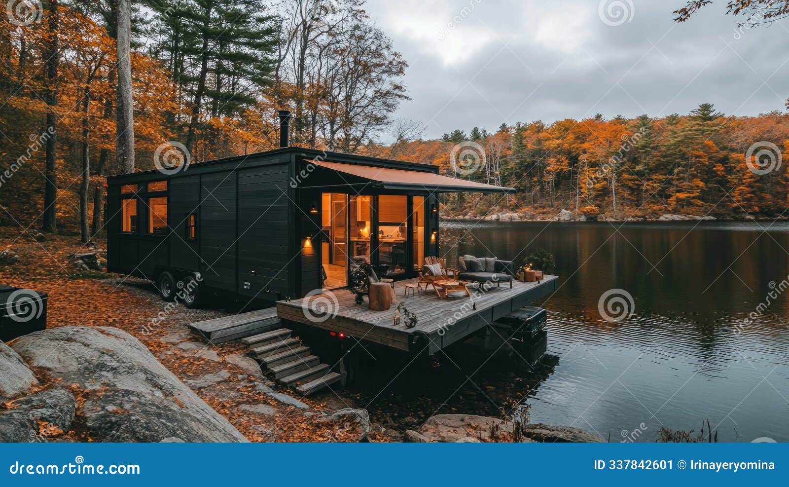tiny modular house on wheels with deck by the serene lakeside in a tranquil autumn setting