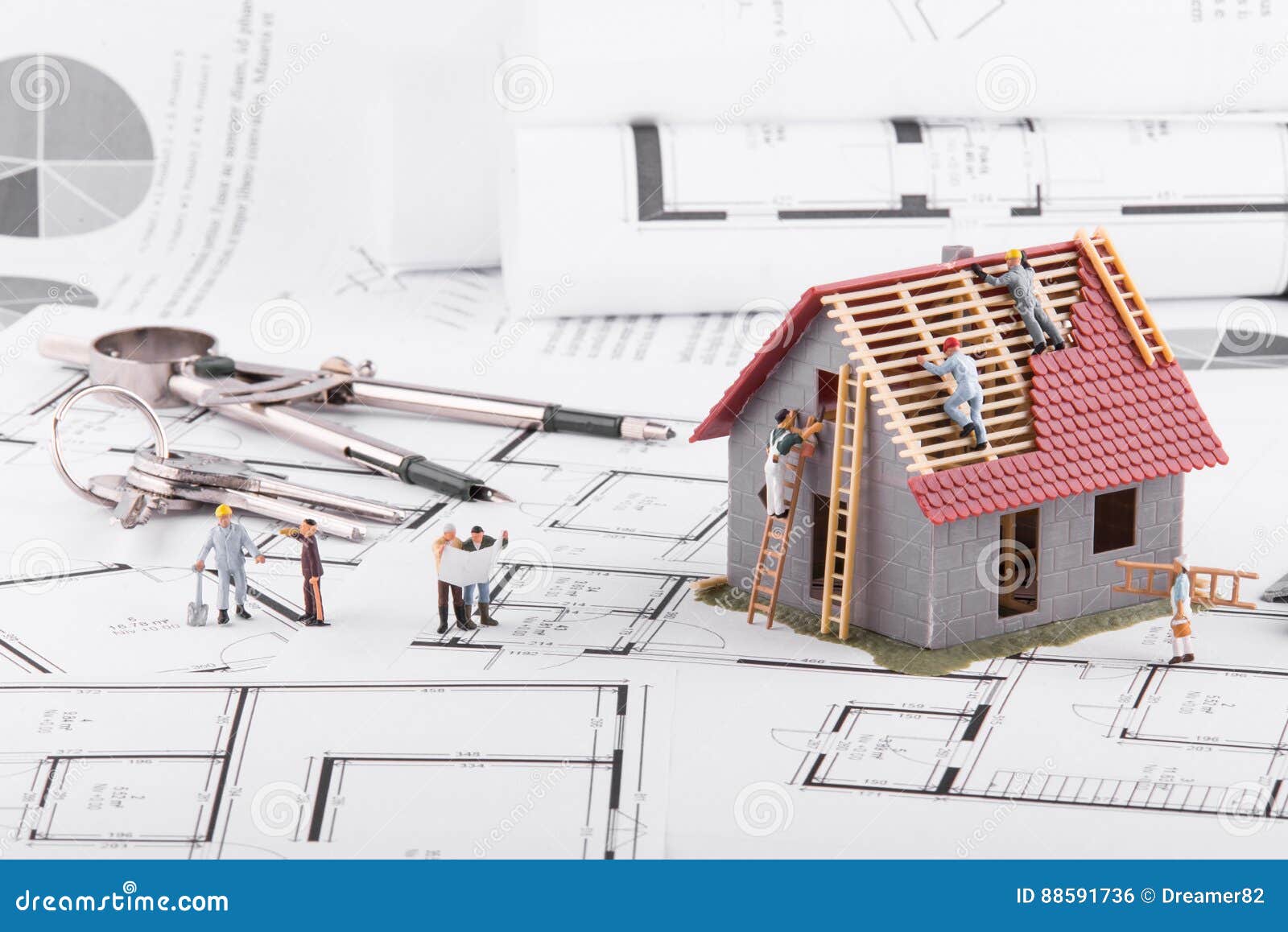 tiny people build houses for architectural plans. the concept of