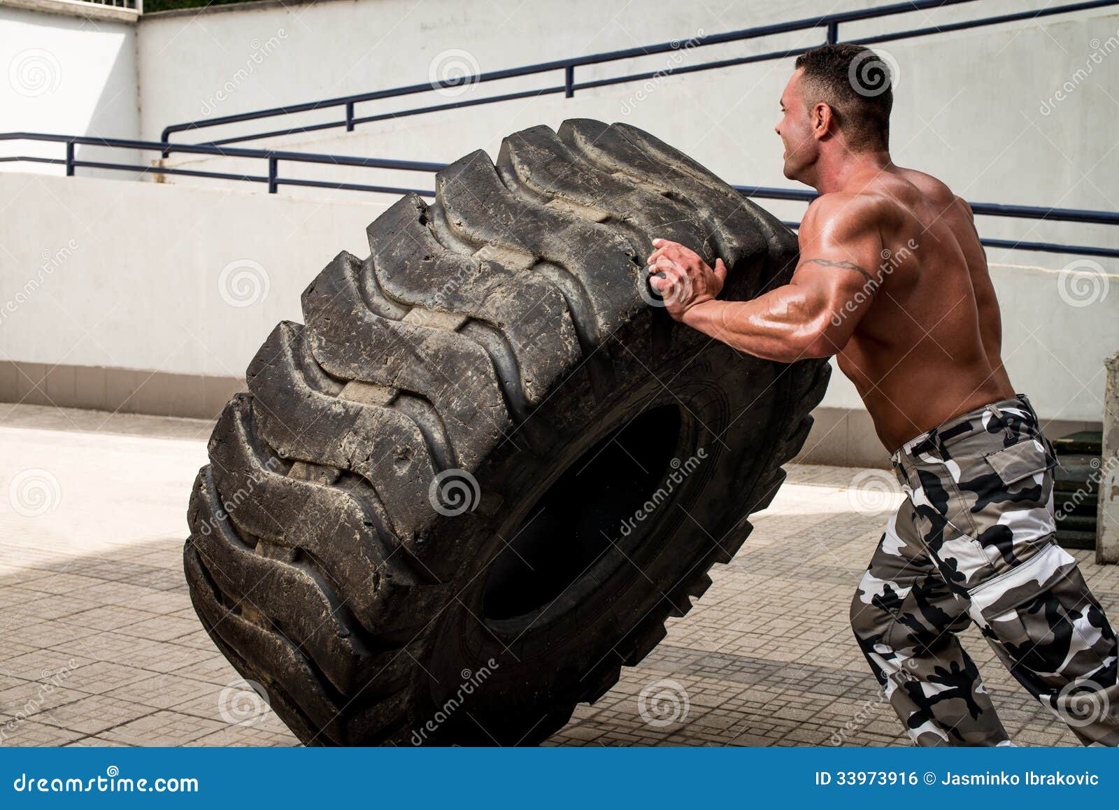 tire-workout-muscular-man-truck-doing-crossfit-style-turning-over-33973916.jpg