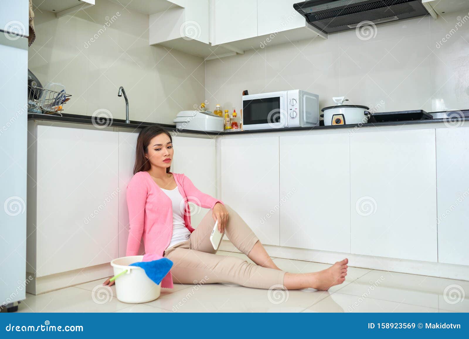 Tired Asian Woman Cleans Floor In The Kitchen Stock Image Image O