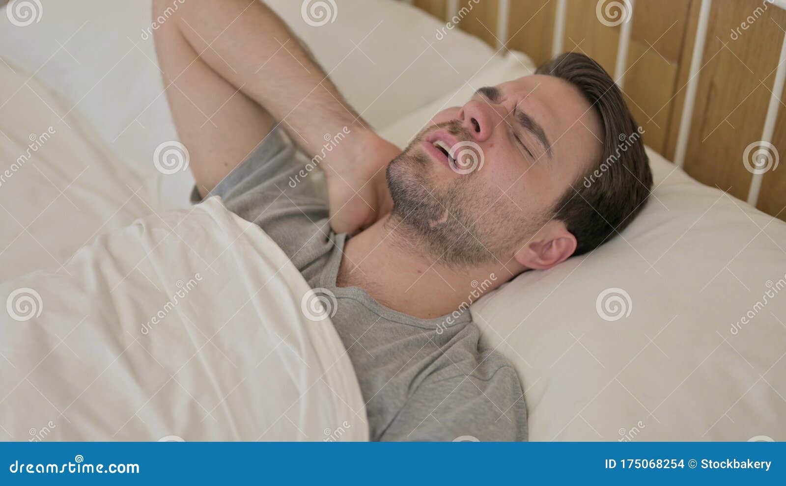 Tired Young Man Having Neck Pain in Bed Stock Photo Image of resting