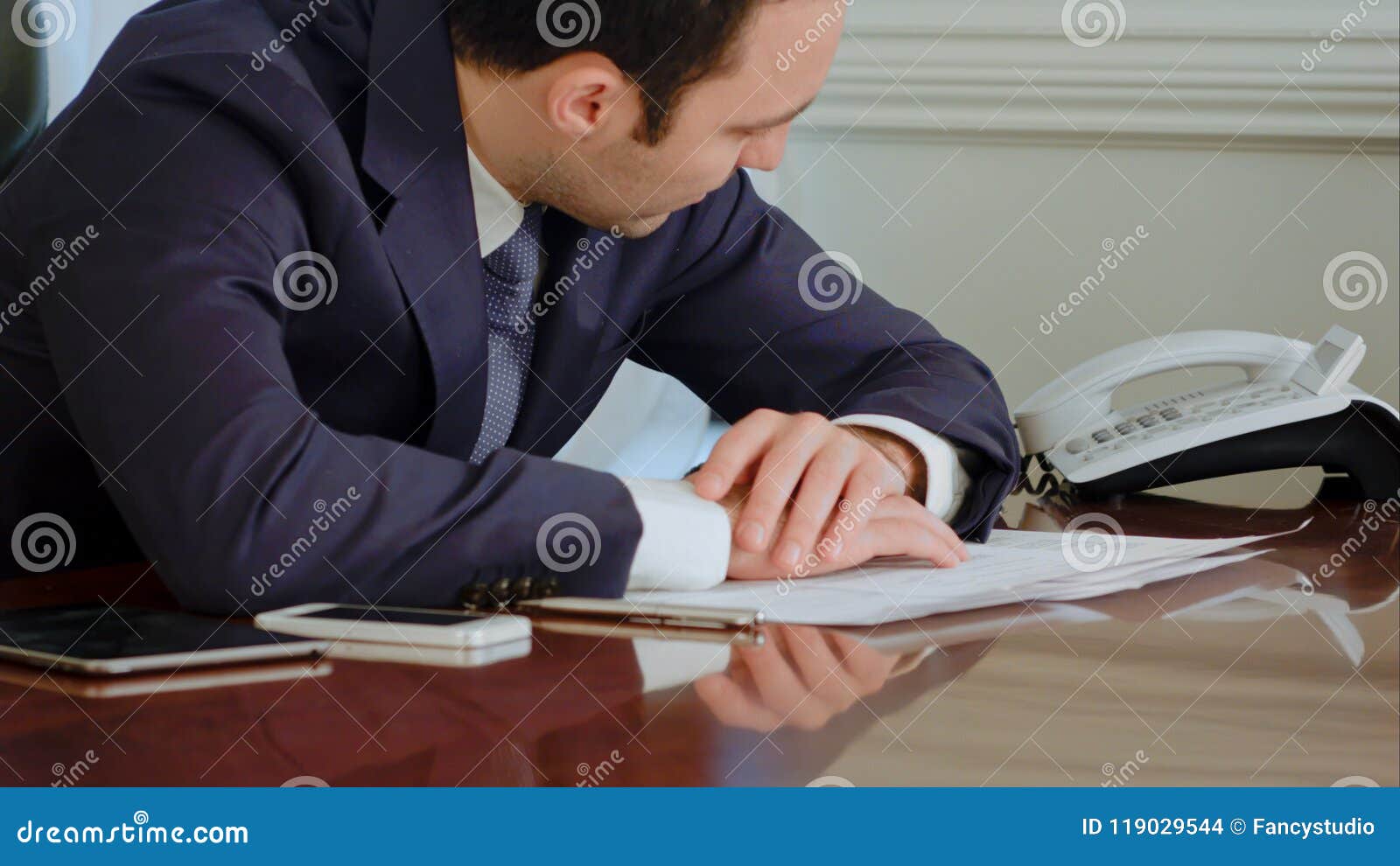 tired businessman awakened by phone call and answer