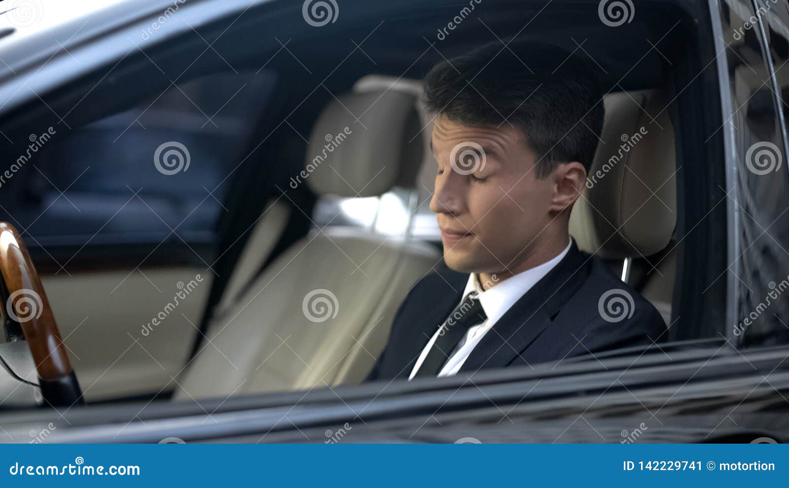tired businessman with closed eyes sitting in car, feeling sleepiness, insomnia
