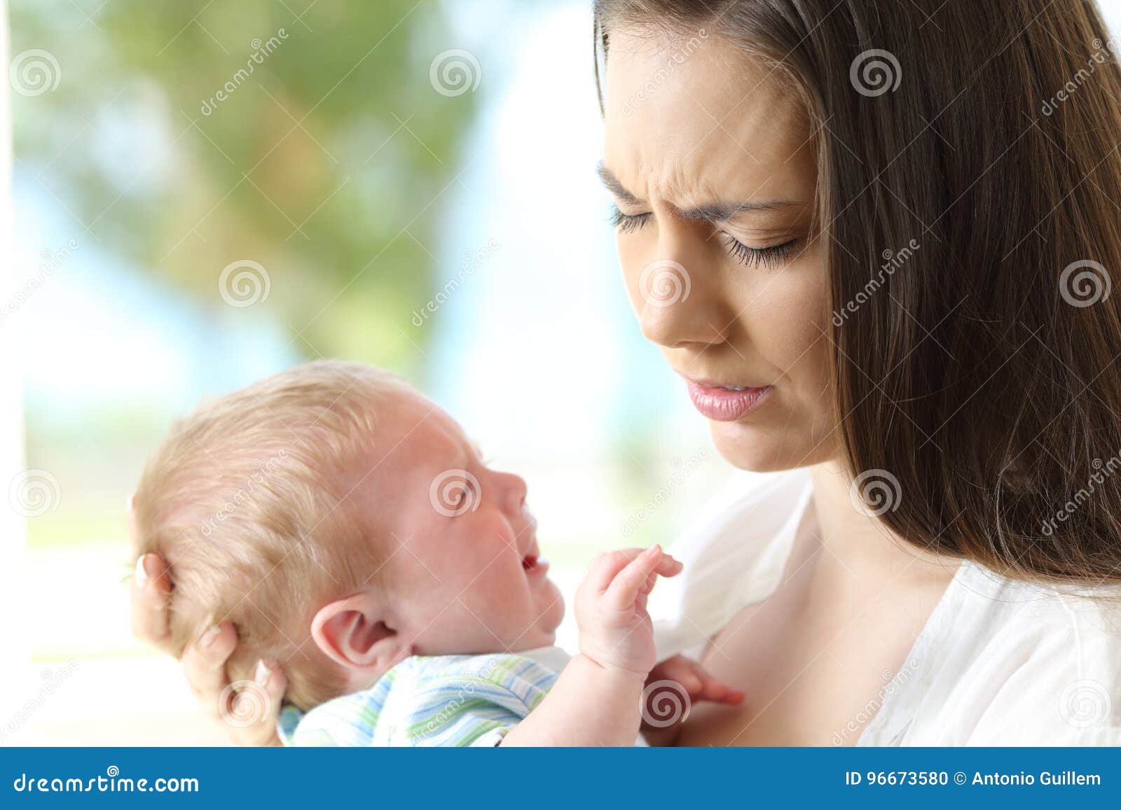 tired desperate mother and baby crying