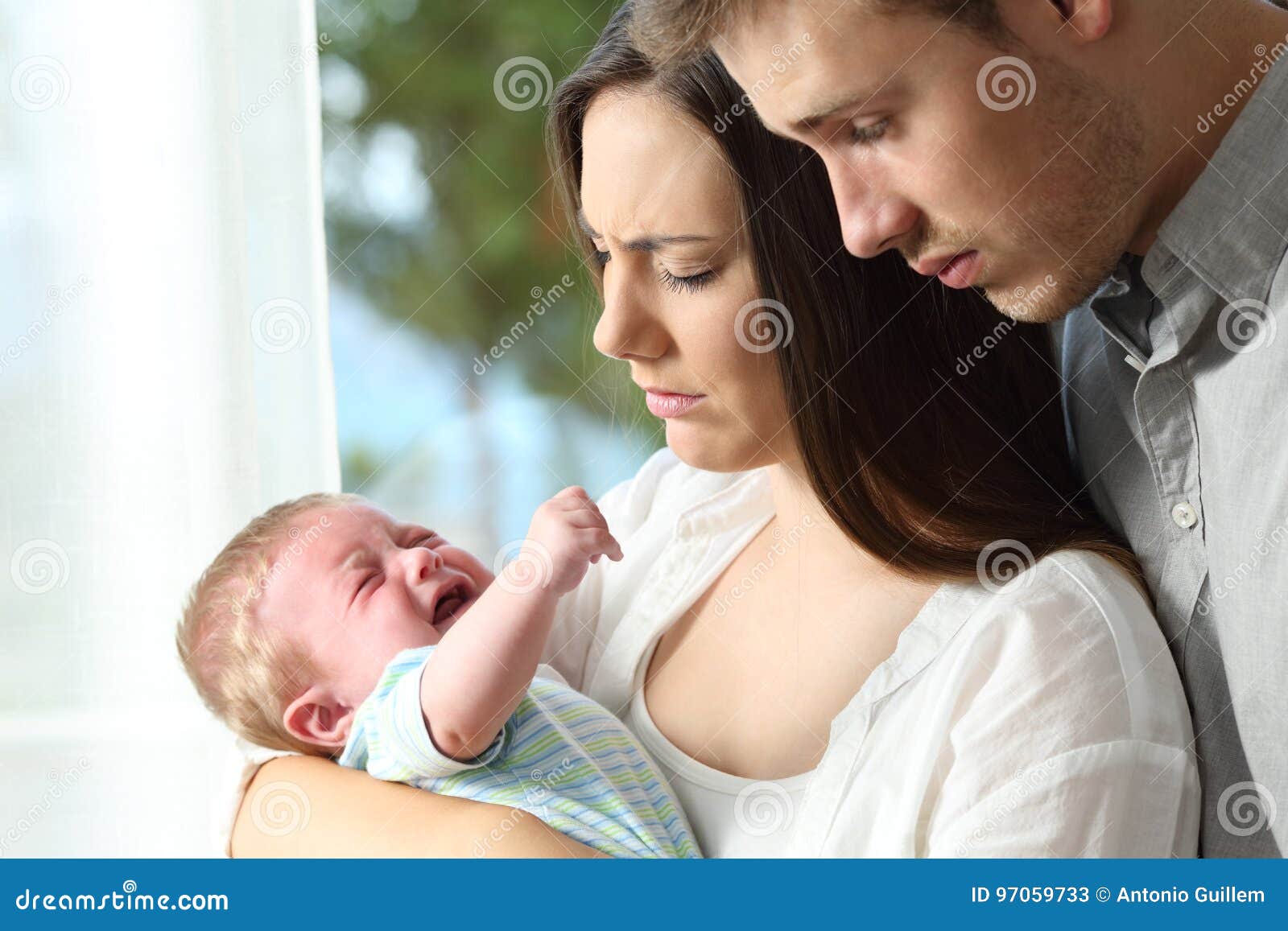 tired desperate parents and baby crying