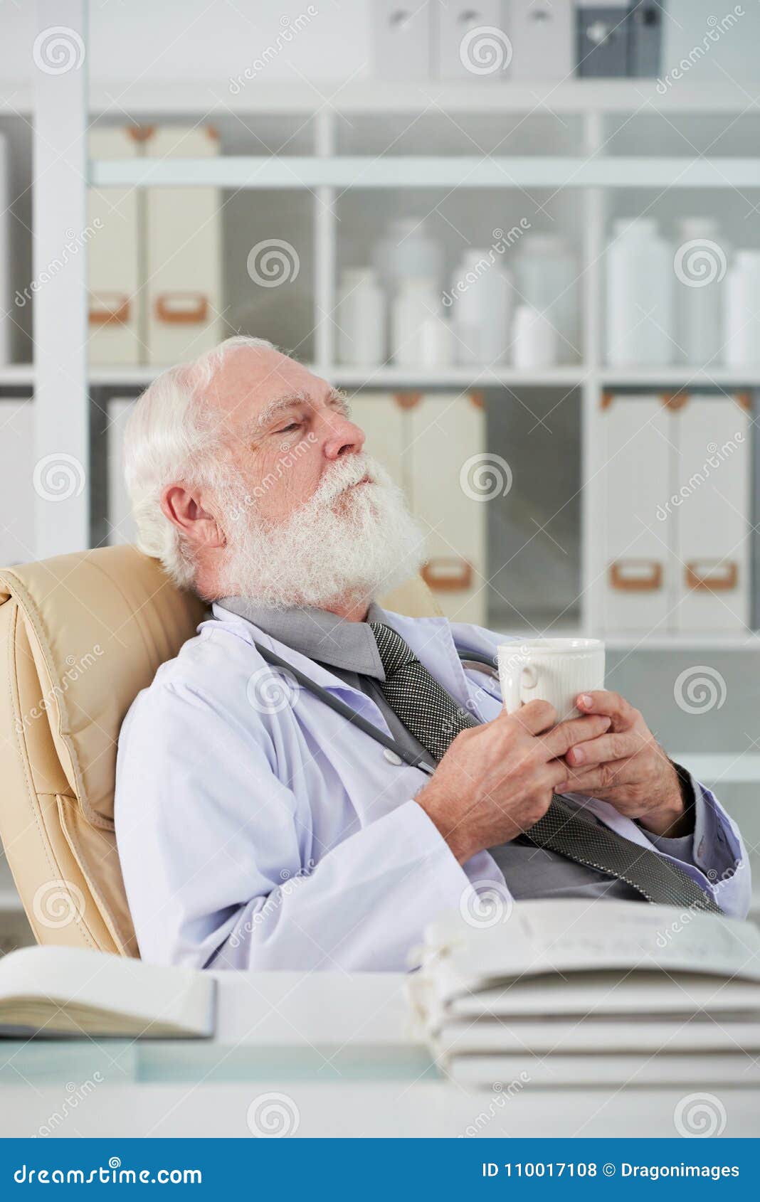 Tired doctor having break stock photo. Image of holding - 110017108