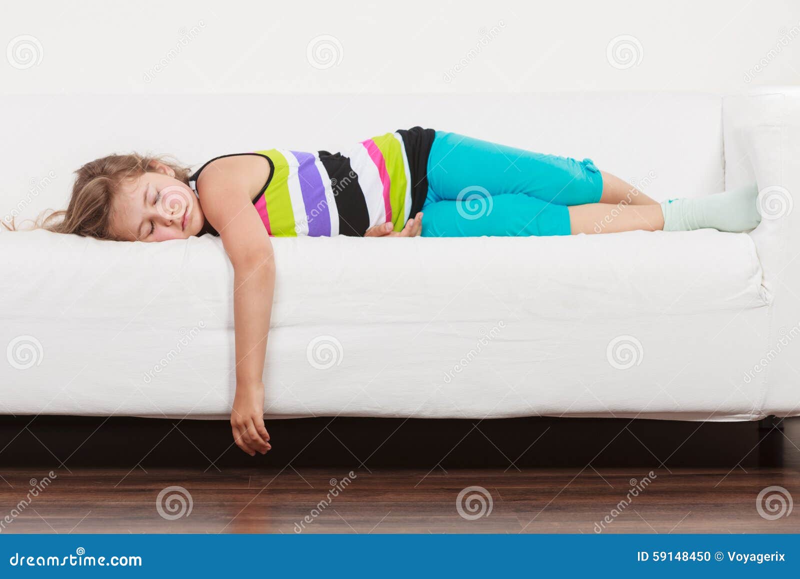 Tired Exhausted Lazy Little Girl Kid Lying On Sofa Stock Photo