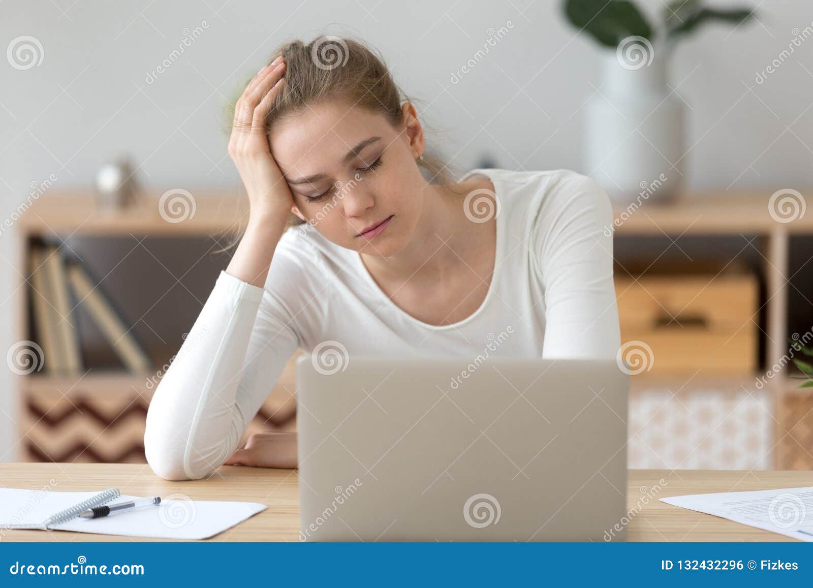 Tired Female Fall Asleep Near Laptop At Home Desk Stock Photo