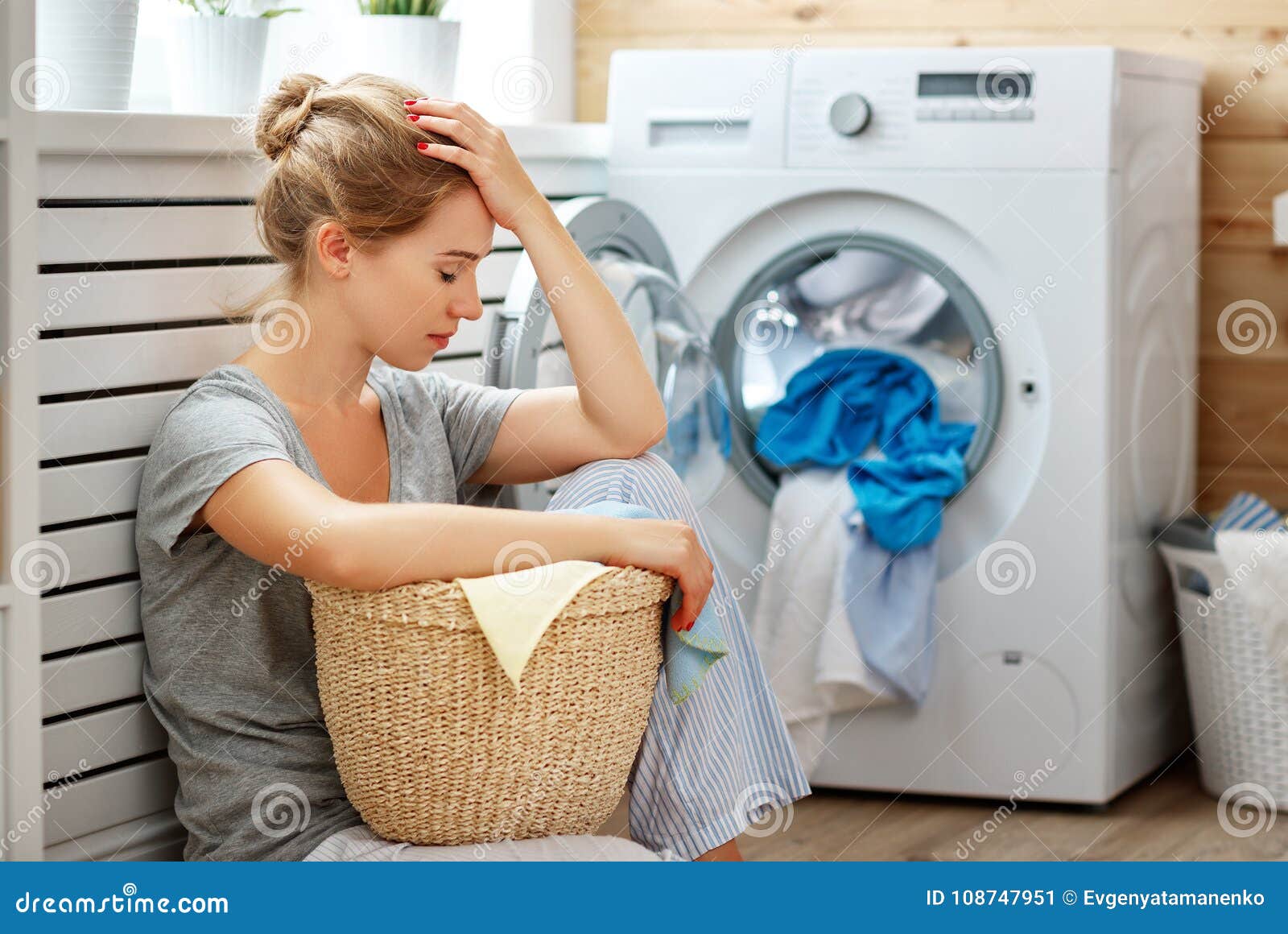 tired housewife woman in stress sleeps in laundry room with wash