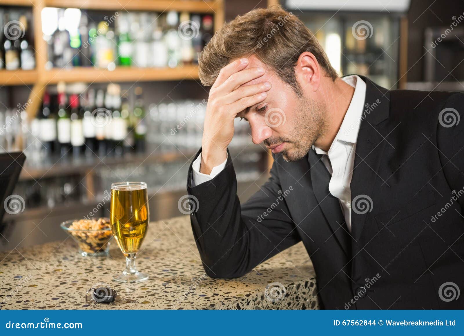 Tired man having a beer stock photo. Image of person - 67562844