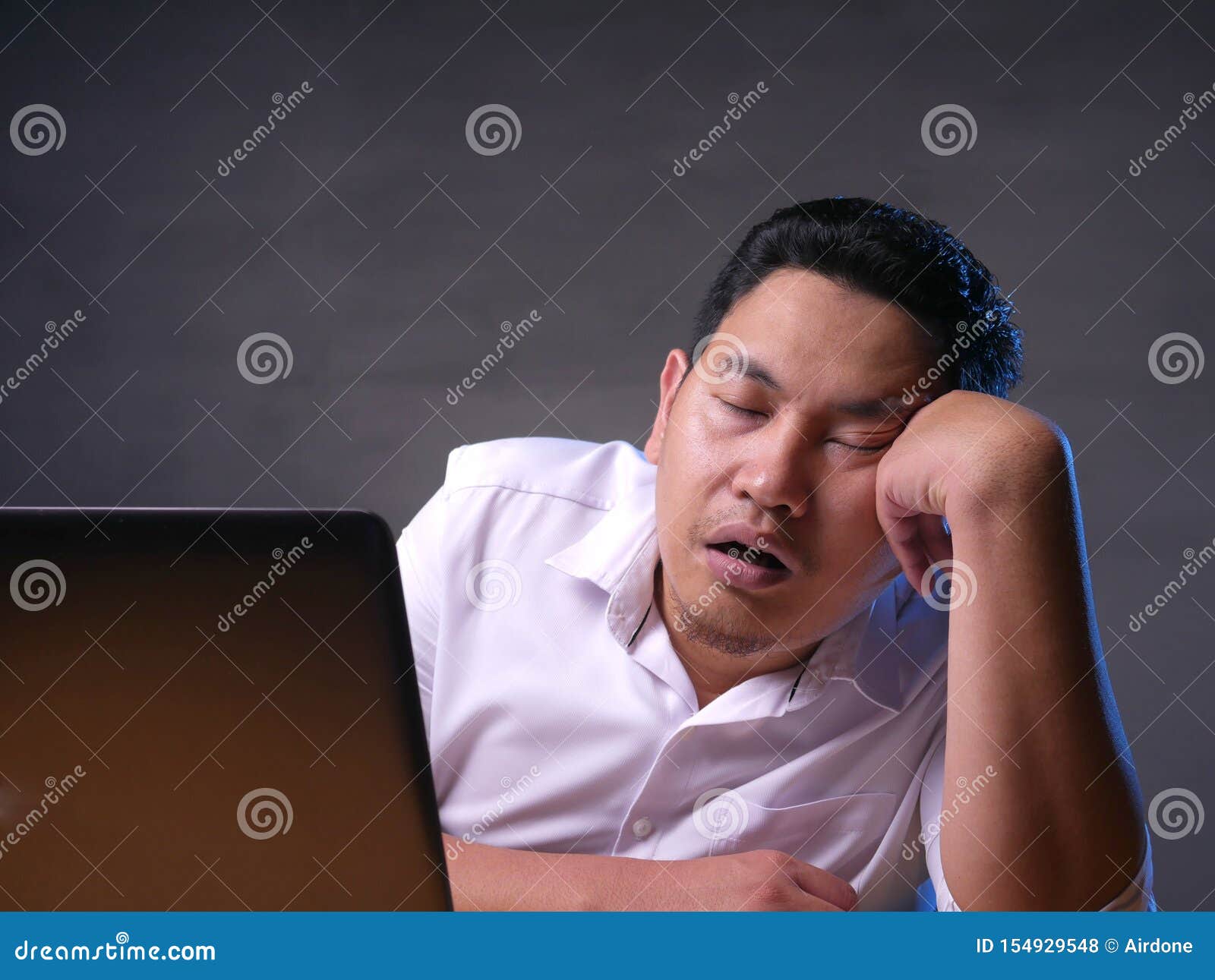 tired sleepy asian businessman having overworked