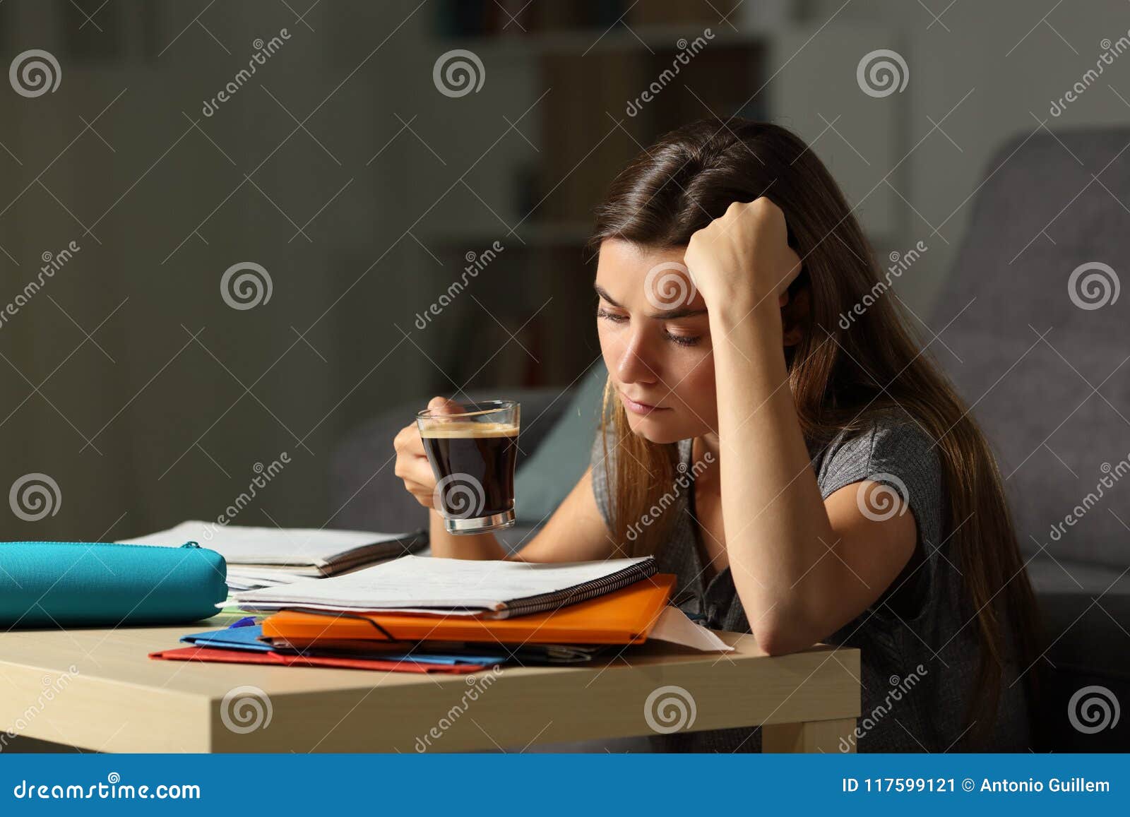 tired student studying late hours drinking coffee