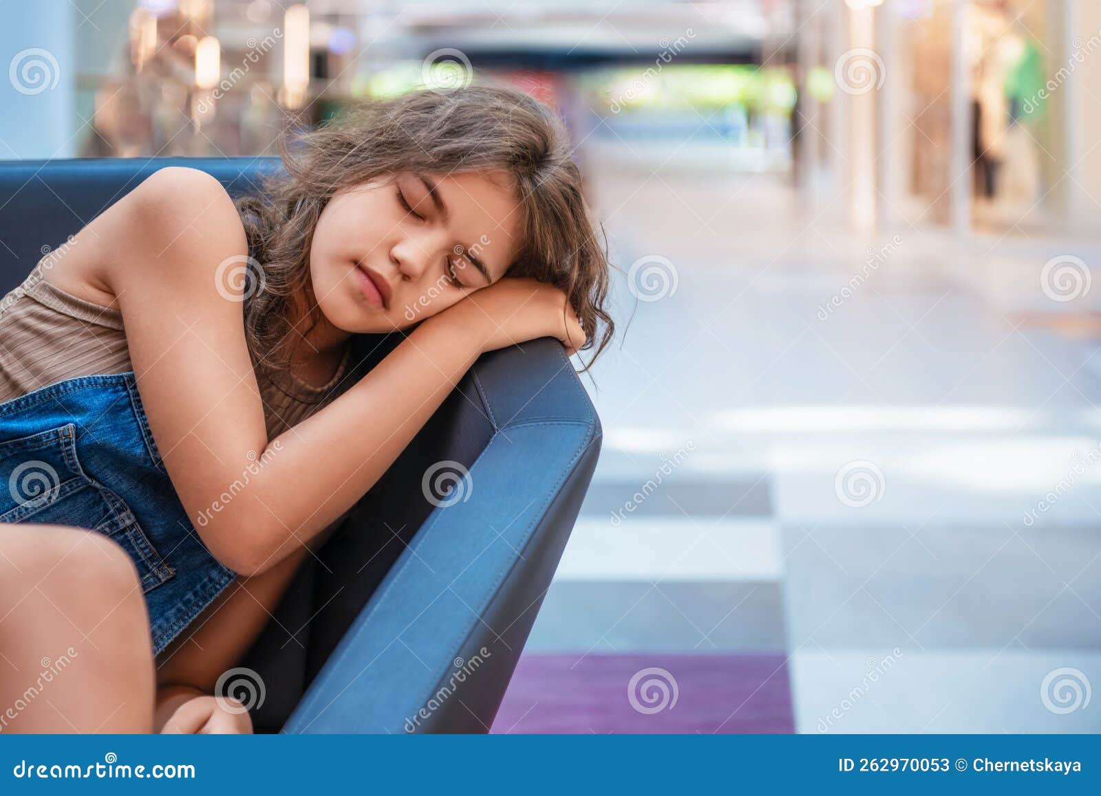 Tired Teenage Girl Sleeping On Sofa In Shopping Mall Stock Image