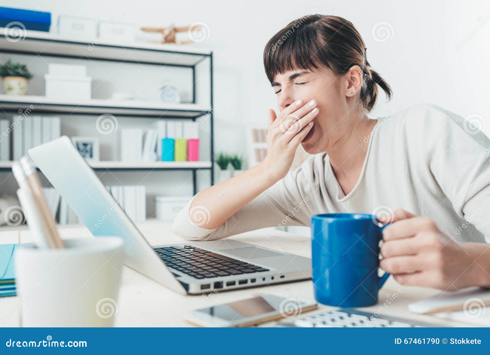 tired woman at office desk