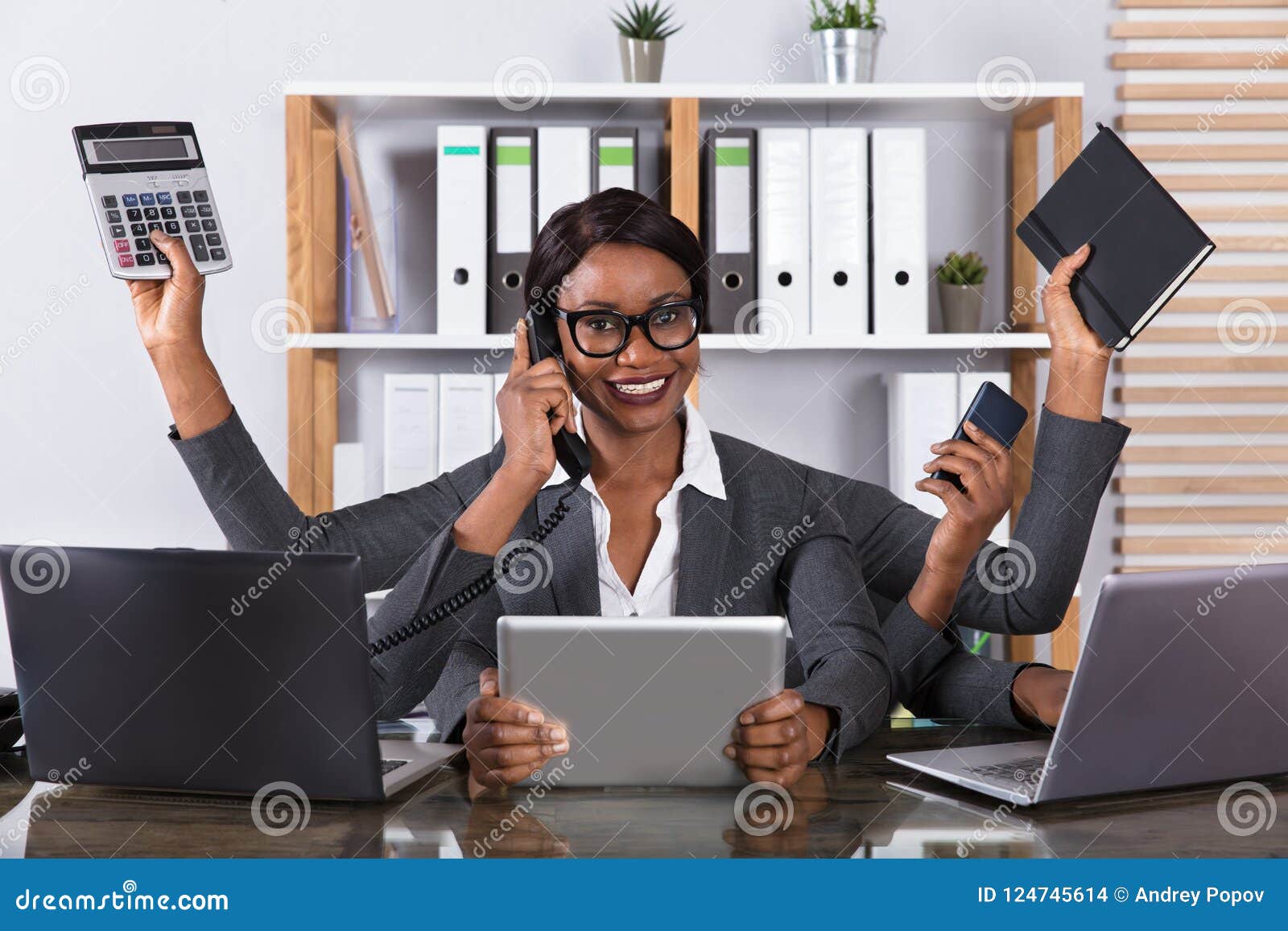 tired woman doing multitasking work on laptop