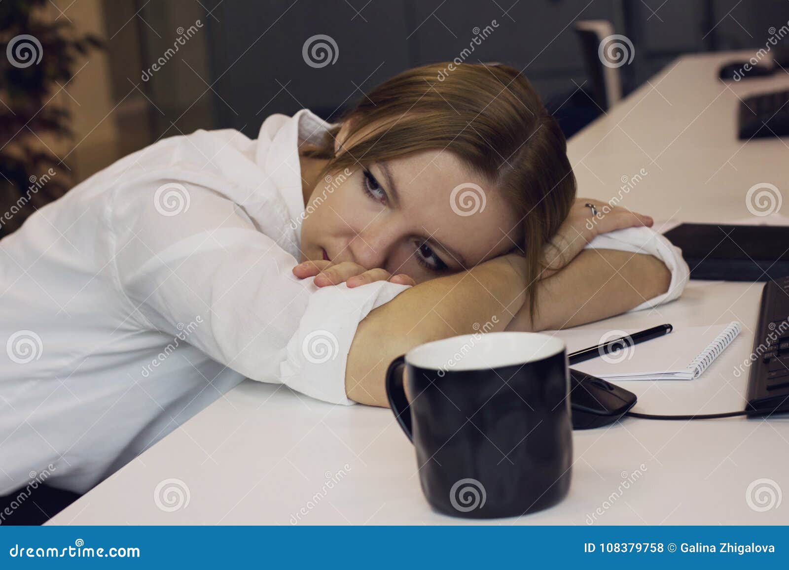 Tired Young Woman Laid Her Head Down On The Desk In The Office